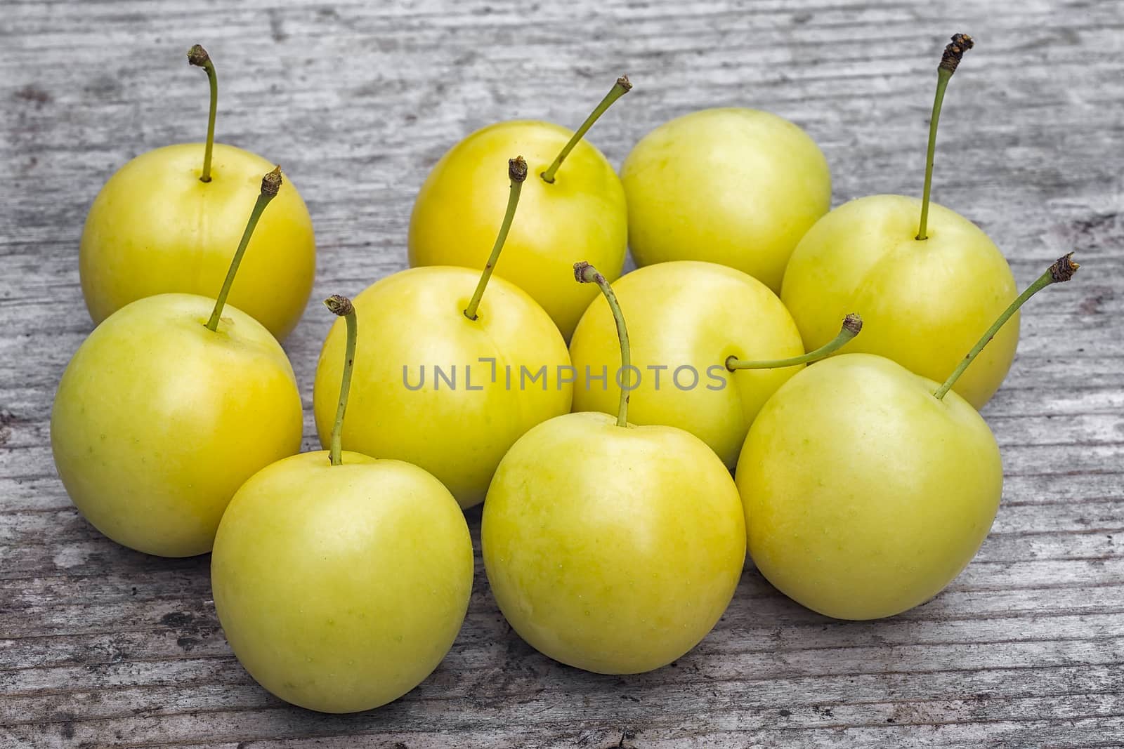 yellow Cherry plum (Prunus cerasifera). ripe of fruit on woody table