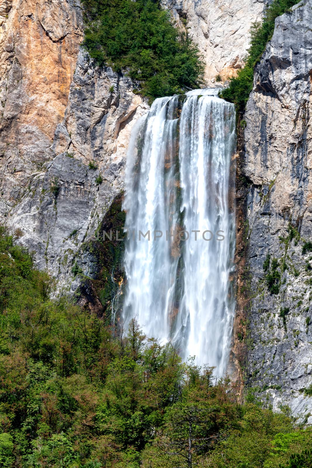 Famous slovenian waterfall Boka in Julian Alps in Triglav National park, Slovenia is one of the highest waterfalls in european Alps with 106m in height, rare view from far, vertical, close zoom