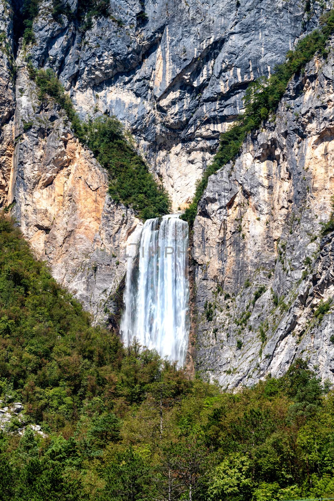 Famous slovenian waterfall Boka Alps in Triglav National park, Slovenia is one of the highest and most magnificient waterfalls in european Alps with 106m in height, vertical close up zoom, rare view