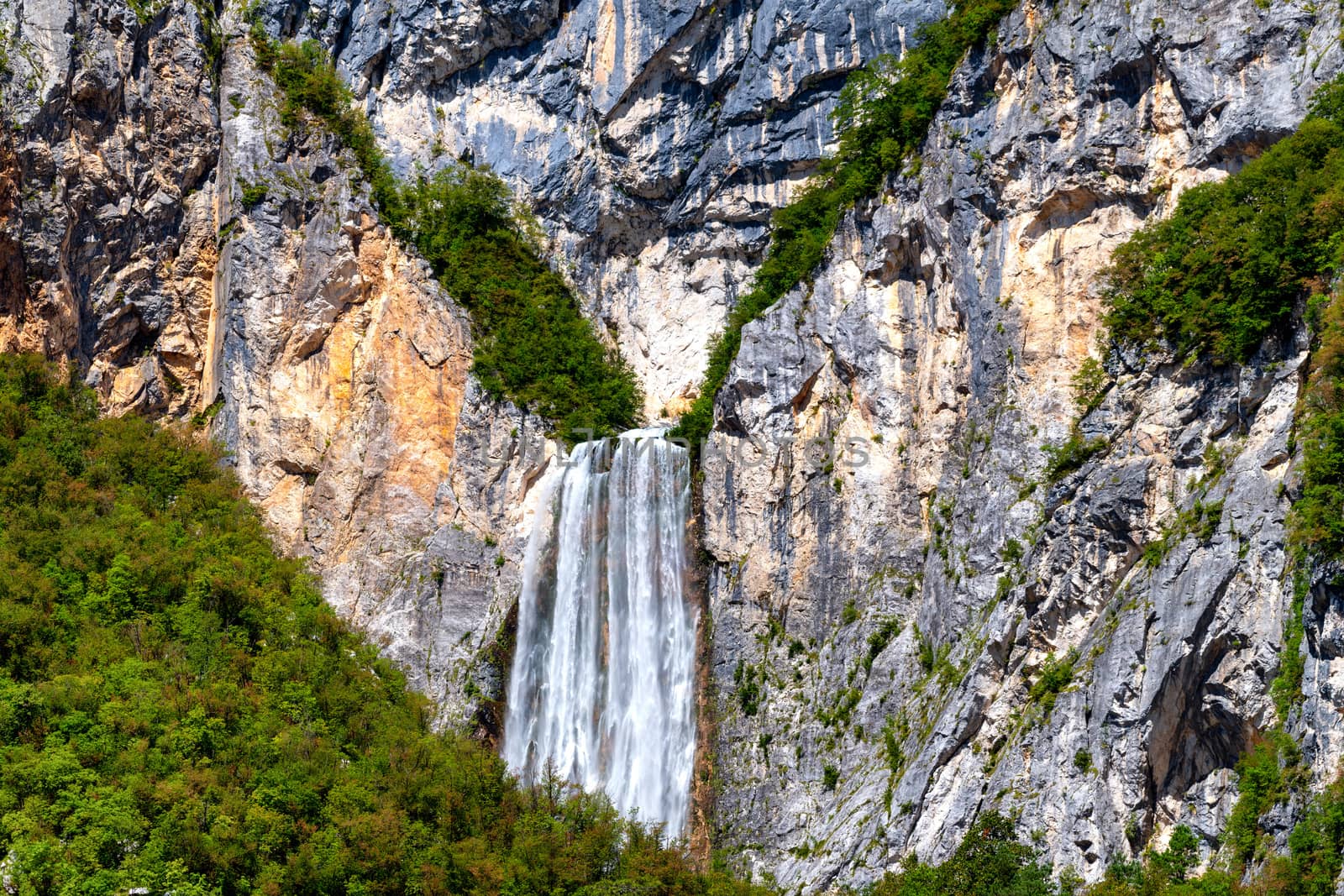 Magnificient waterfall Boka in Julian Alps in Triglav National park, Slovenia is one of the highest and most scenic waterfalls with 106m in height, rare view from Cezsoca, zoomed in, close, horizontal