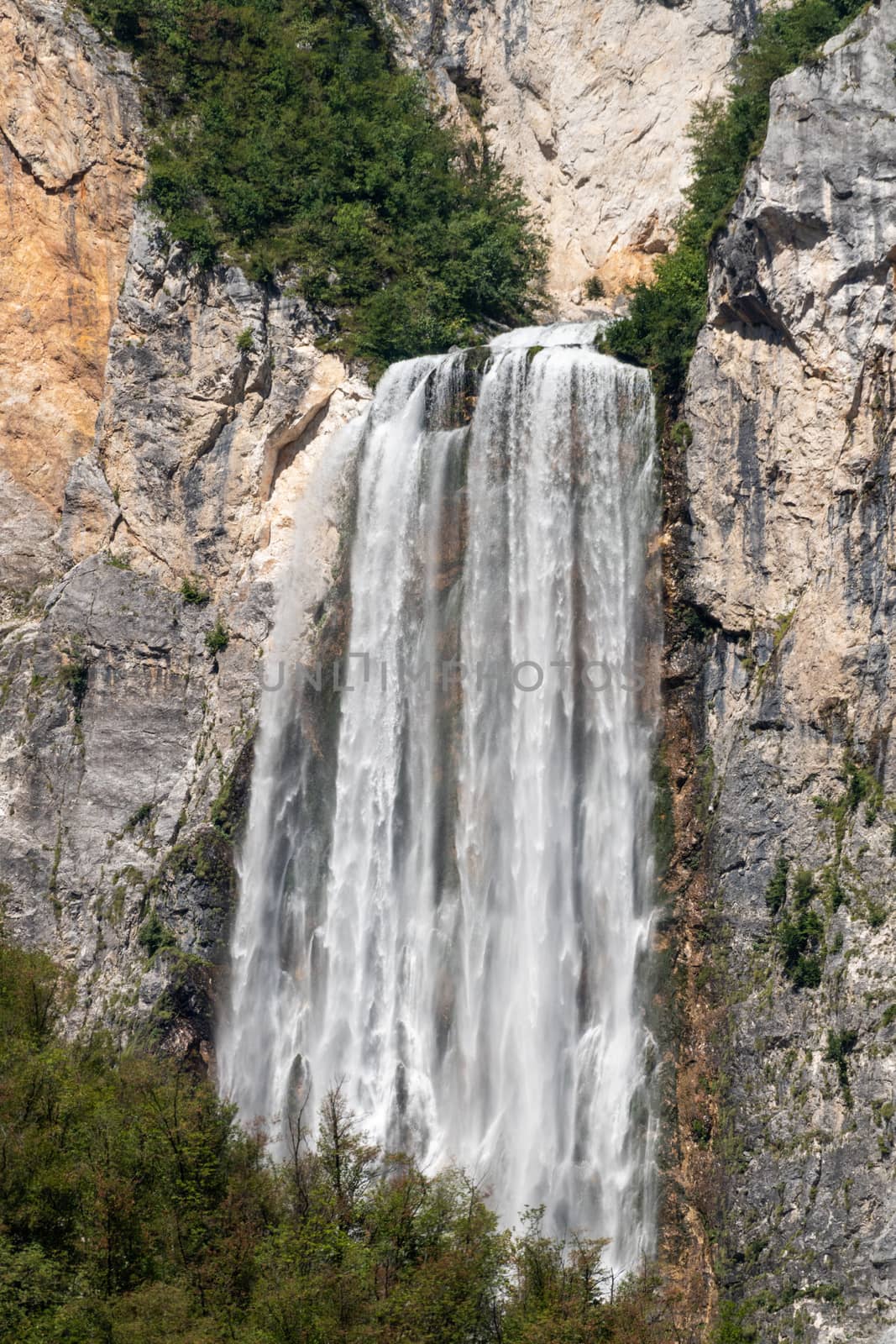 Famous slovenian waterfall Boka, European Alps in Triglav National park, Slovenia and with 106m in height a rare and magnificient view from far, vertical, close zoom