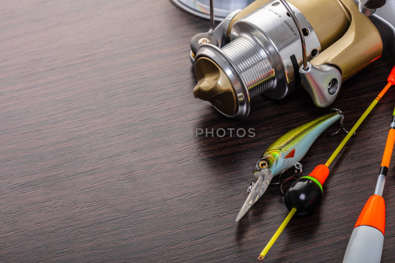 Coil and floats for a fishing rod on a wooden background