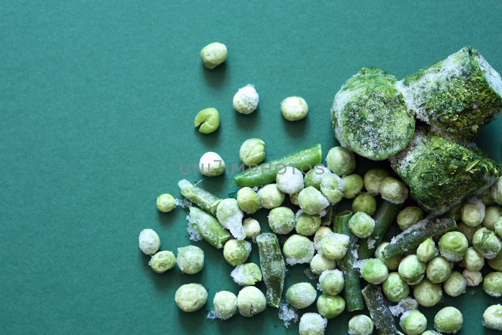 Frozen bean and pea closeup on old green background