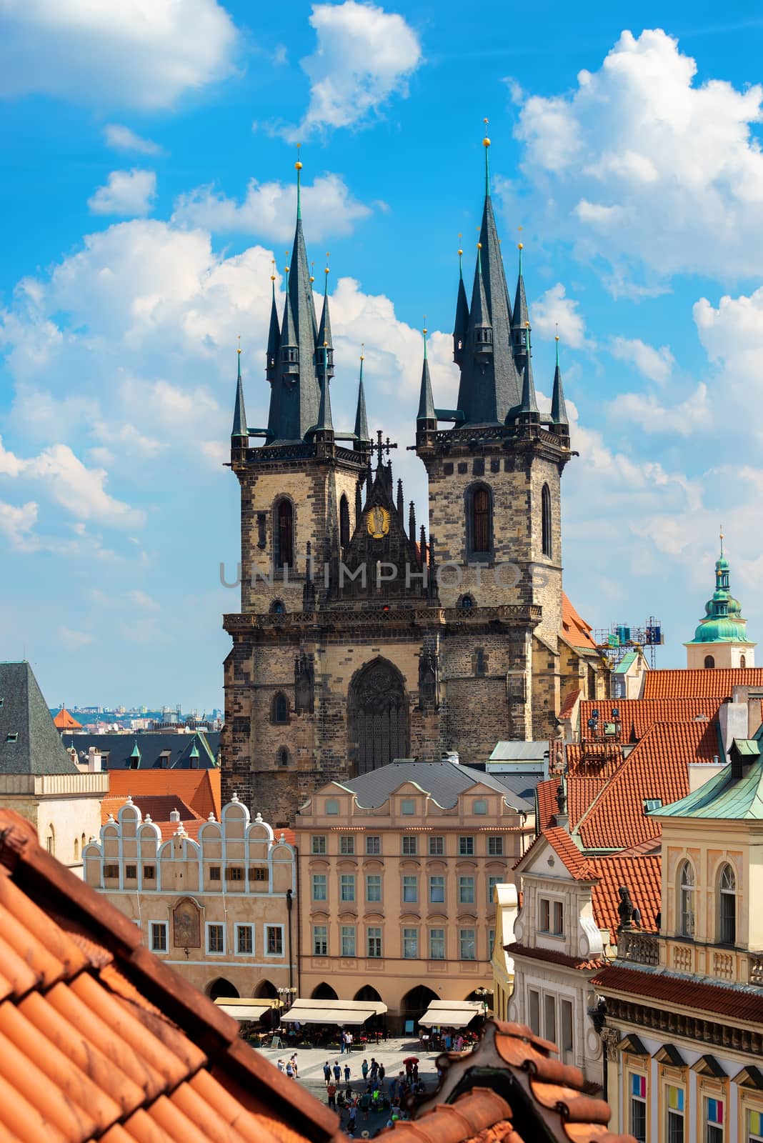 View on magestic Tynsky cathedral and red tile roofs of Prague from above