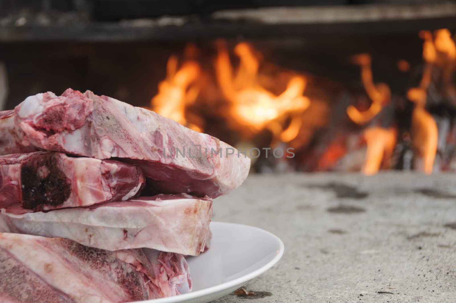 Raw steaks fiorentina-style, typical of Tuscany, Italy, ready to be cooked in a wood burning oven