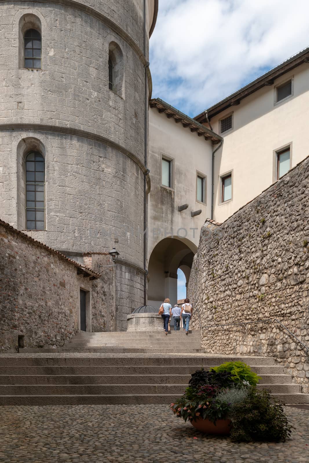 Street in the ancient medieval city of Cividalewith stone buildings and cobblestones, narrow street leading to Piaza del Duomo