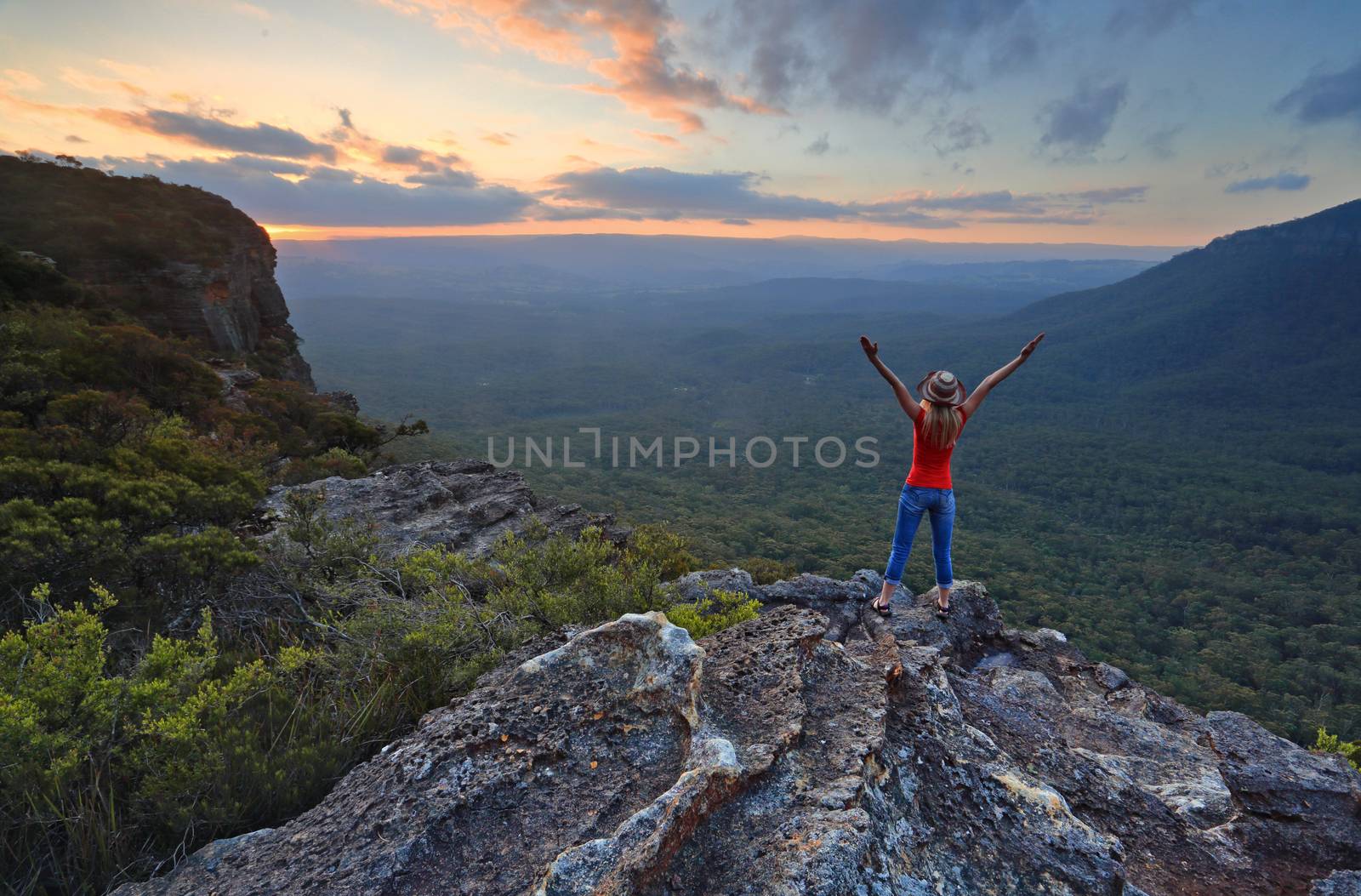 Hiker enjoys magnificent views from mountain top to valley views in Katoomba Blue Mountains.