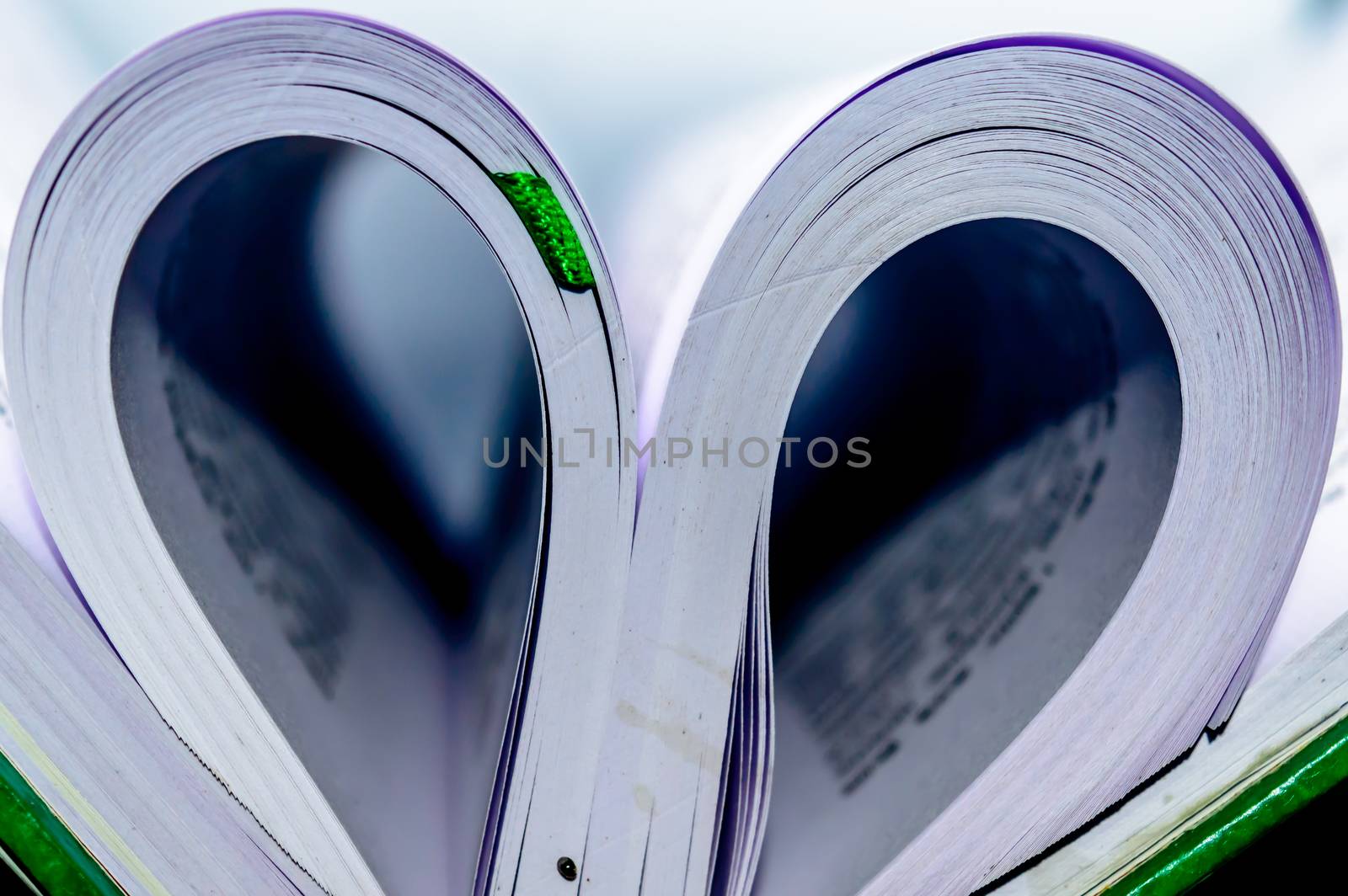 Close up heart shape from paper book with blur background. Heart book page - vintage effect style pictures. Concept for valentine's day.