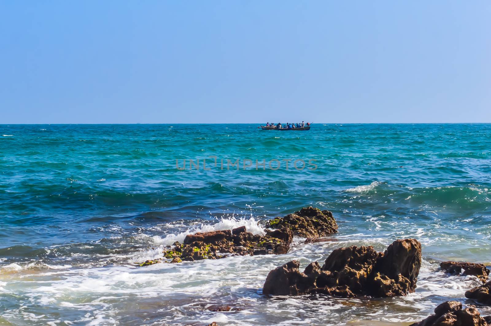 Photograph of Rowing Boat in Sea taken from a distance by sudiptabhowmick