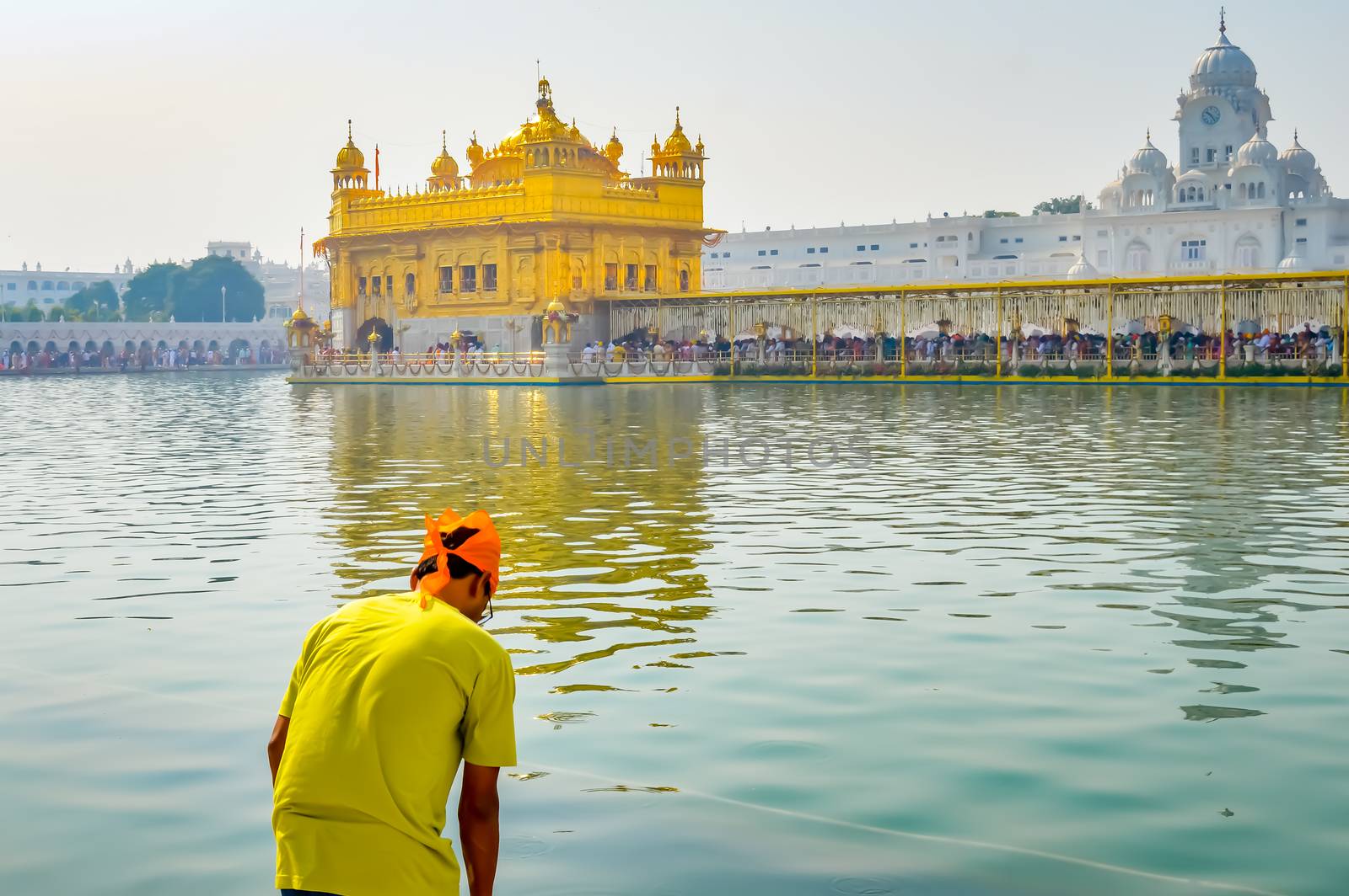 Sikh pilgrim praying in holy tank near Golden Temple (Sri Harmandir Sahib), Amritsar, INDIA by sudiptabhowmick