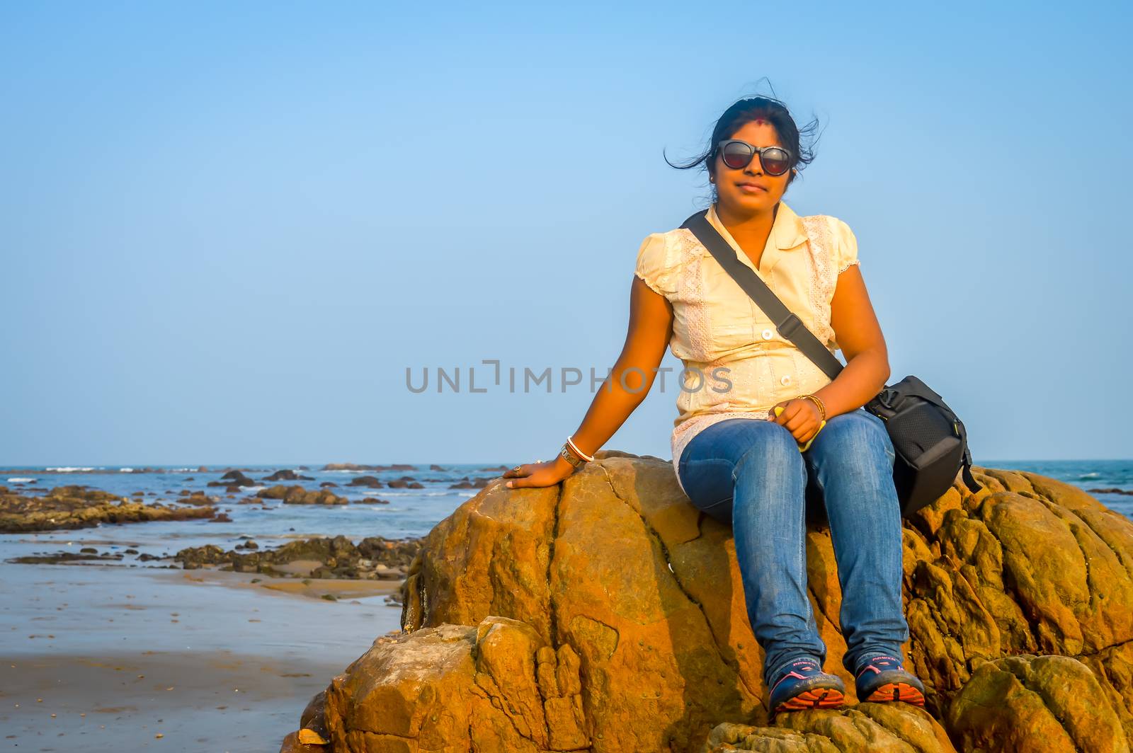 Cute woman relaxing on the tropical beach, outside tropical resort, Vacation concept. Goa India