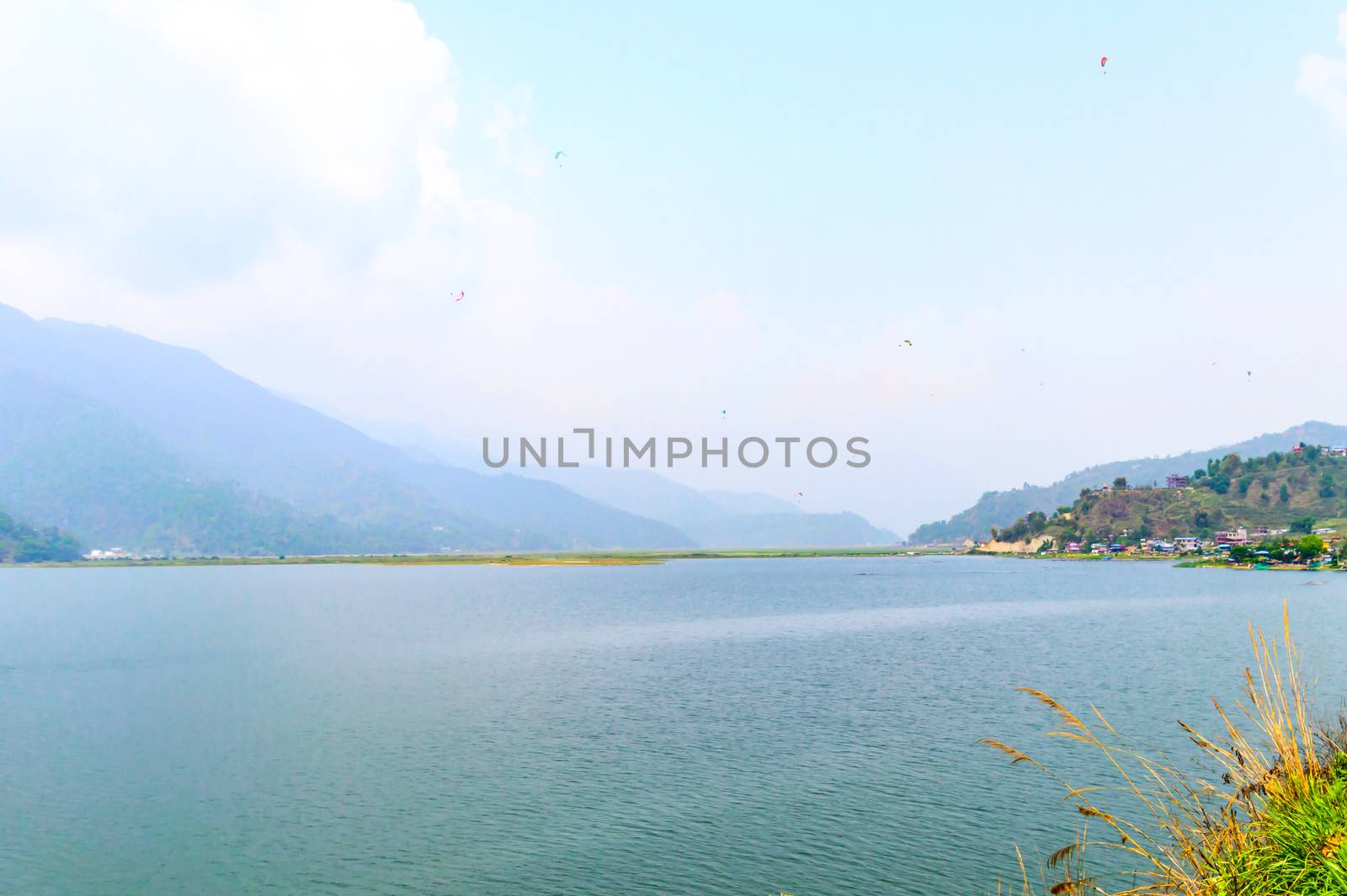 Photograph of sky, lake, mountain and reflexion Near Pokhara Lake at Kathmandu Nepal. Snap in portrait, landscape, wide screen. Vintage film look. Nature Freedom, Travel, Energy, Environment Concept.