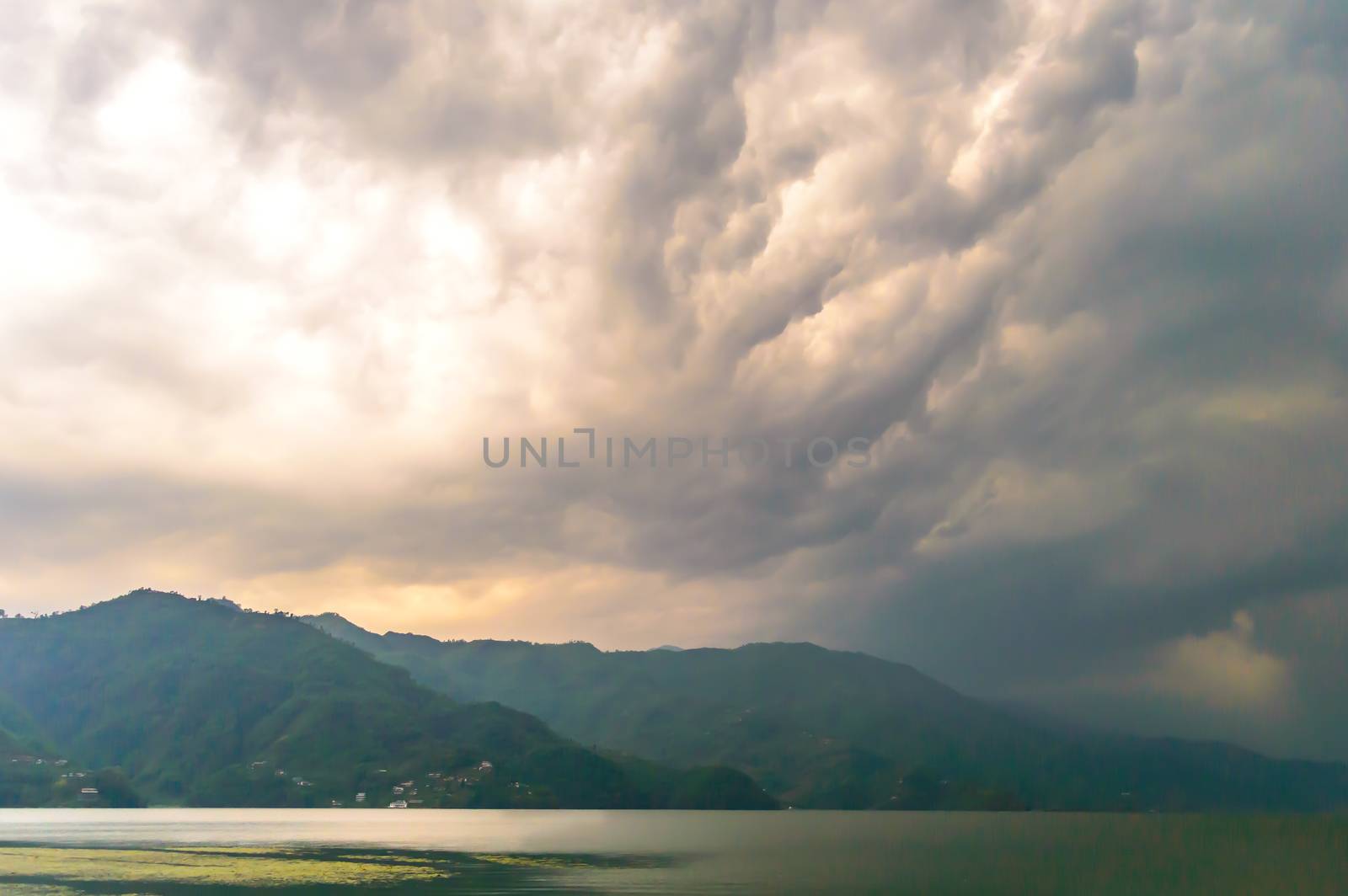 Photograph of cloud, lake, mountain and reflexion Near Pokhara Lake at Kathmandu Nepal. Snap in portrait, landscape, wide screen. Vintage film look. Nature Freedom, Vivid, Energy, Environment Concept.