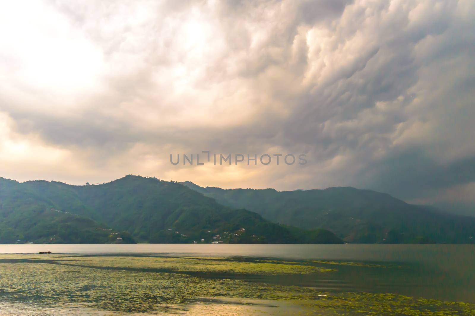 Photograph of cloud, lake, mountain and reflexion Near Pokhara Lake at Kathmandu Nepal. Snap in portrait, landscape, wide screen. Vintage film look. Nature Freedom, Vivid, Energy, Environment Concept. by sudiptabhowmick