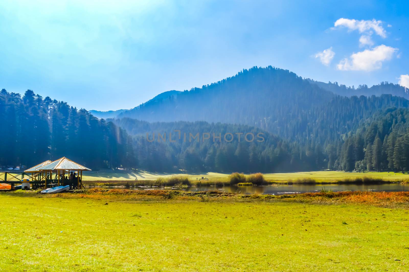 A beautiful golf course on a hill station with road blue sky trees clouds. Captured in sunny day hill station India taken landscape style useful for background wallpaper screen saver Vacation Concept