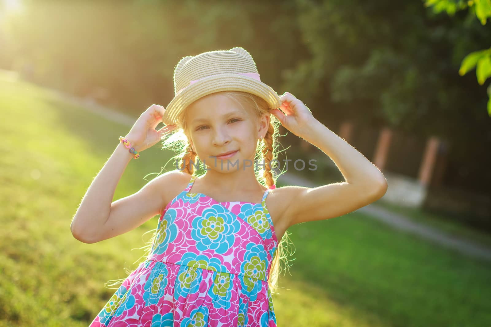 Pretty teen girl posing in hat among summer and sunset by Angel_a