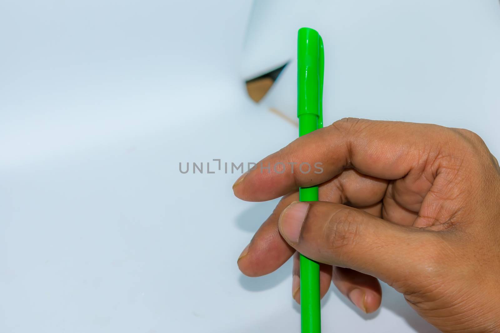 Close up of hand carrying a pen. Popular gesture of communication in business or day to day life.