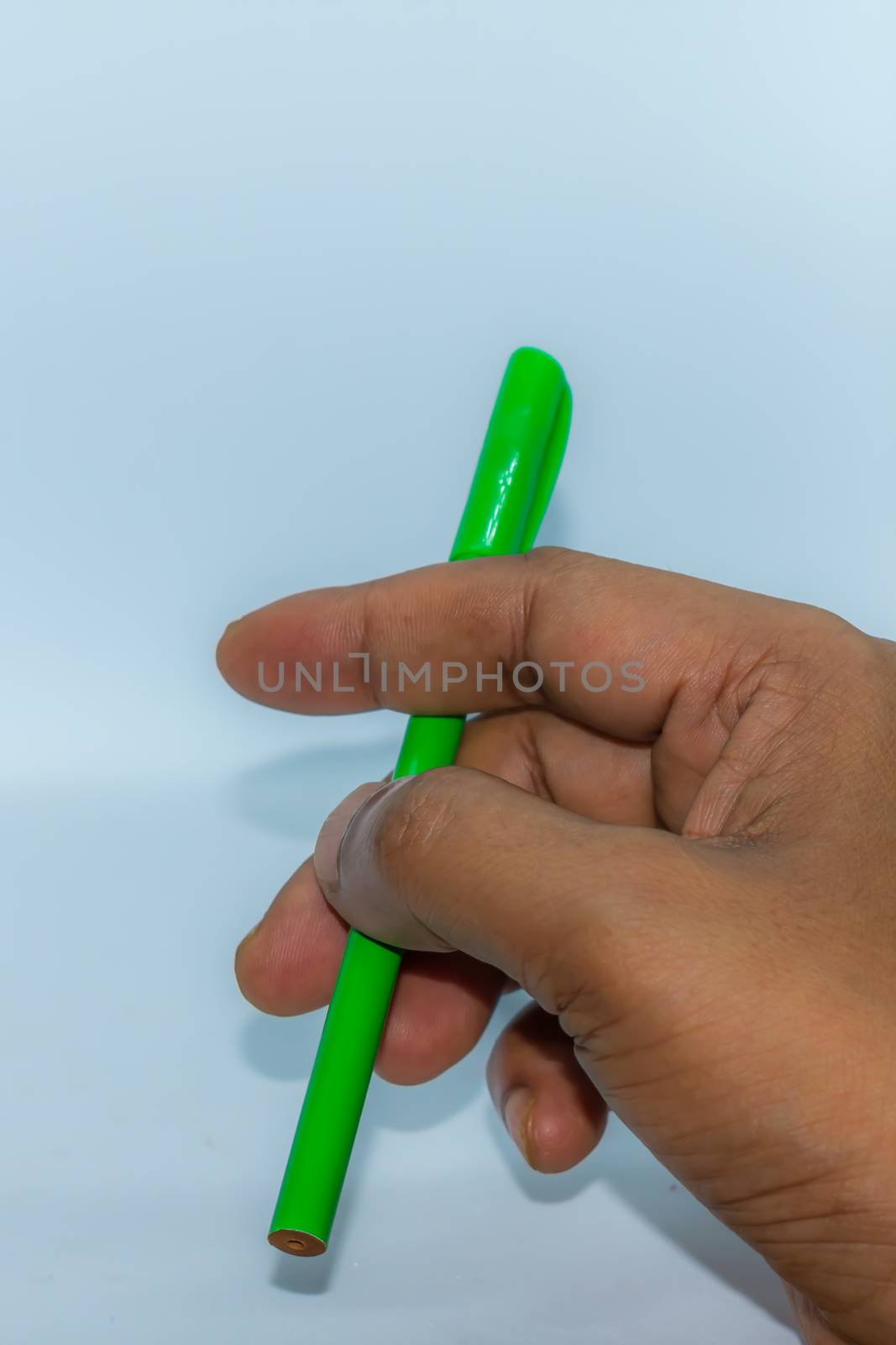 Close up of hand carrying a pen. Popular gesture of communication in business or day to day life.