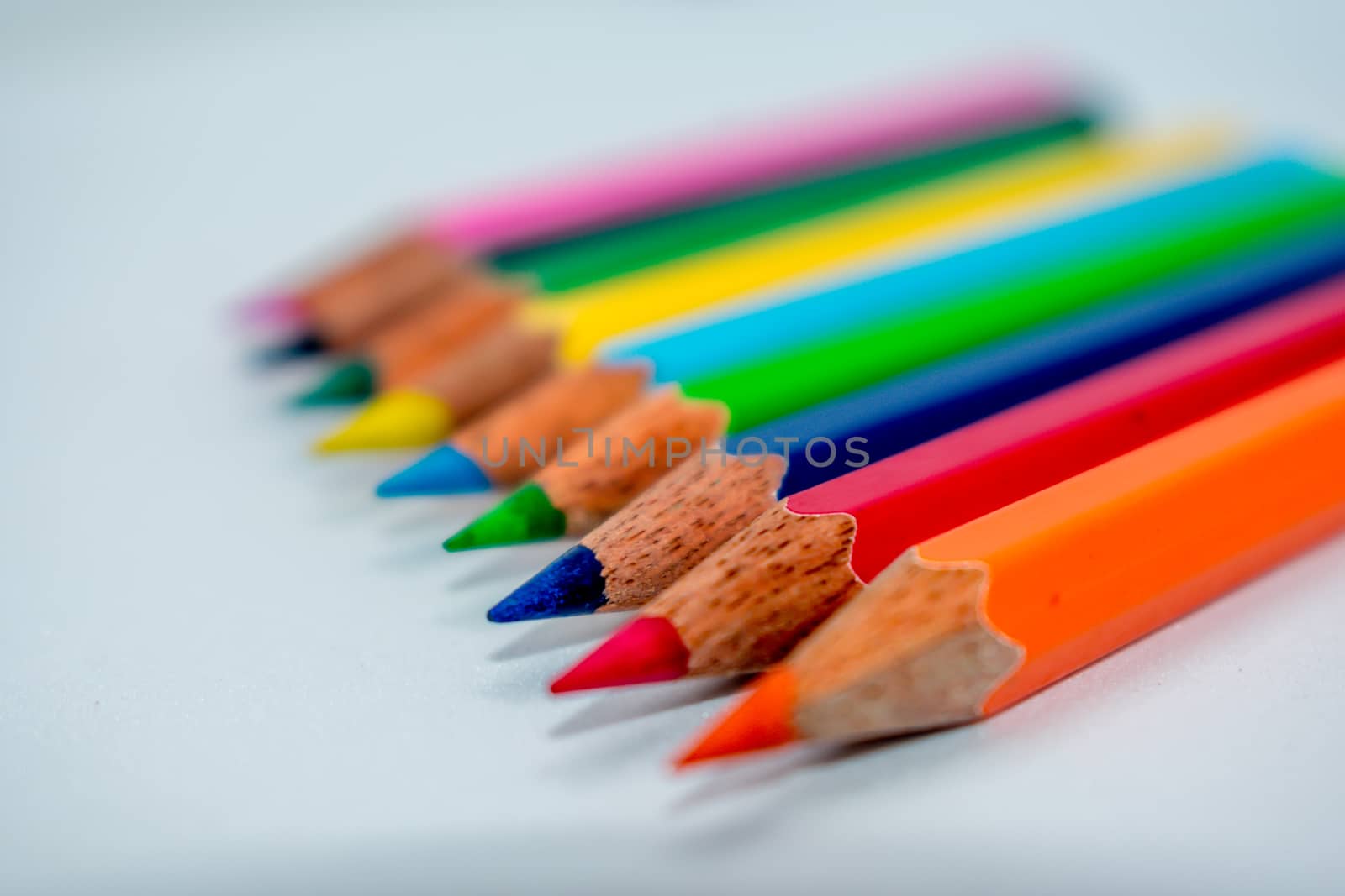 Pencils lined up in shallow focus. by sudiptabhowmick