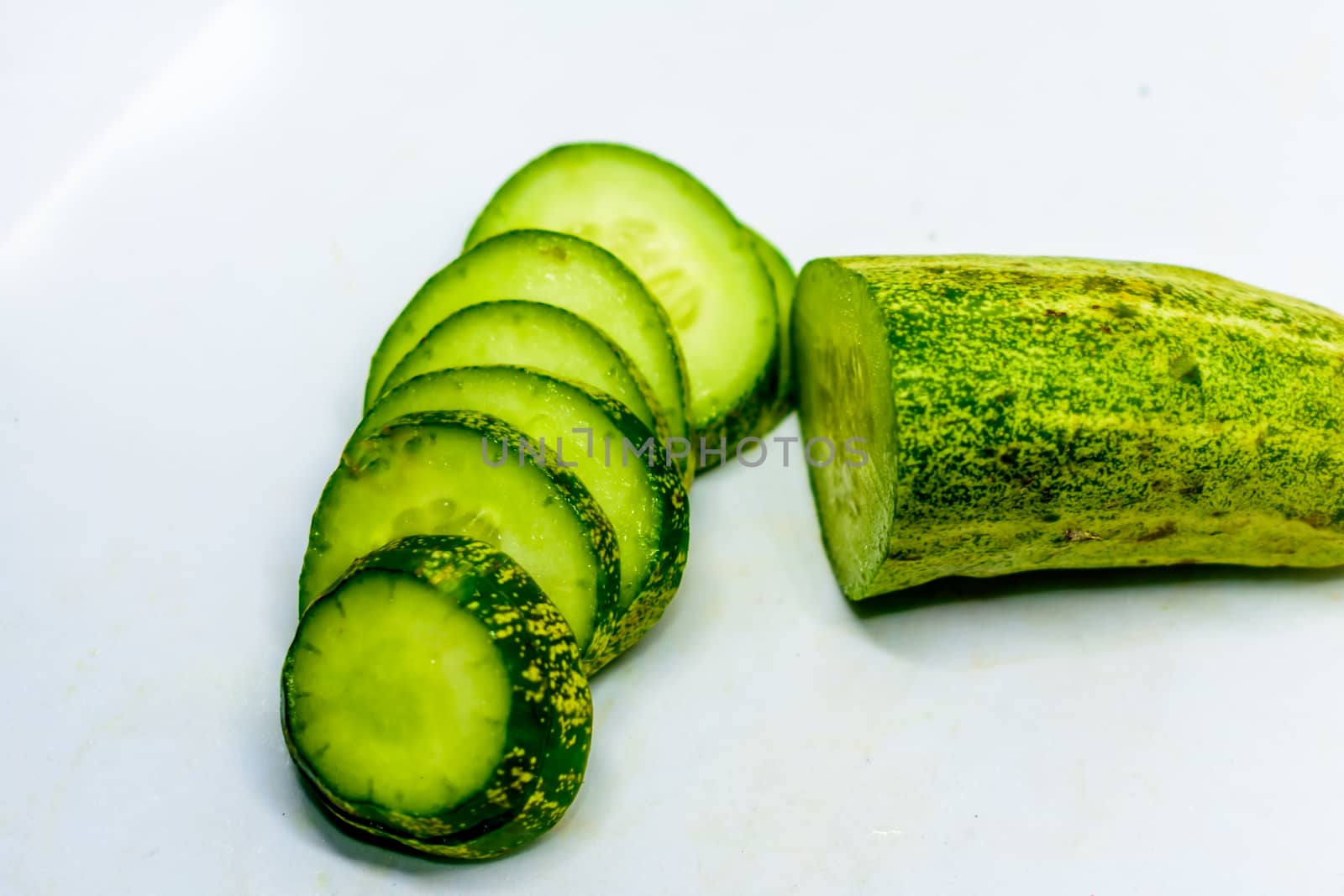 Cucumber and slices isolated over white background.