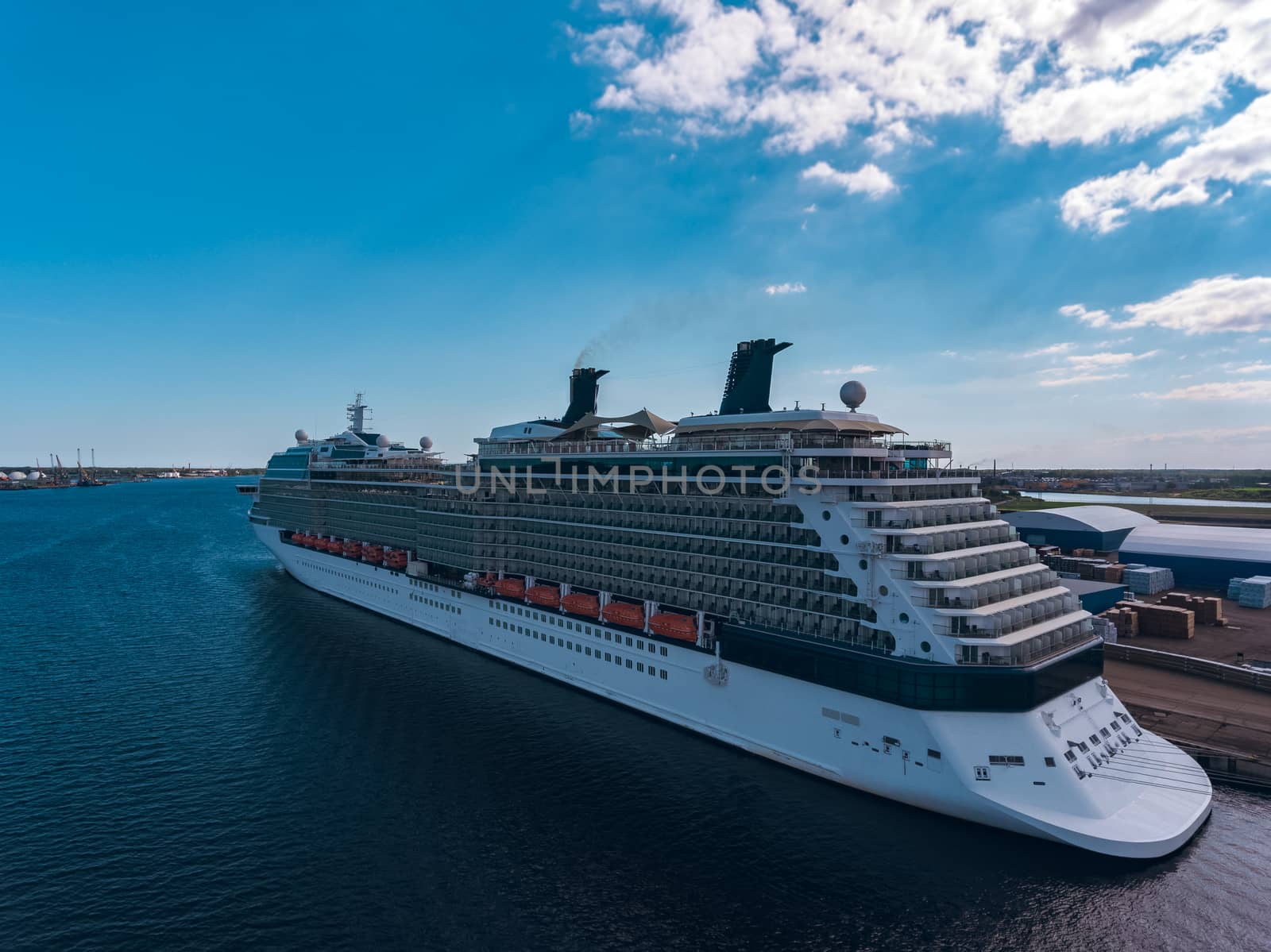 Big white passenger ship moored at the cargo port