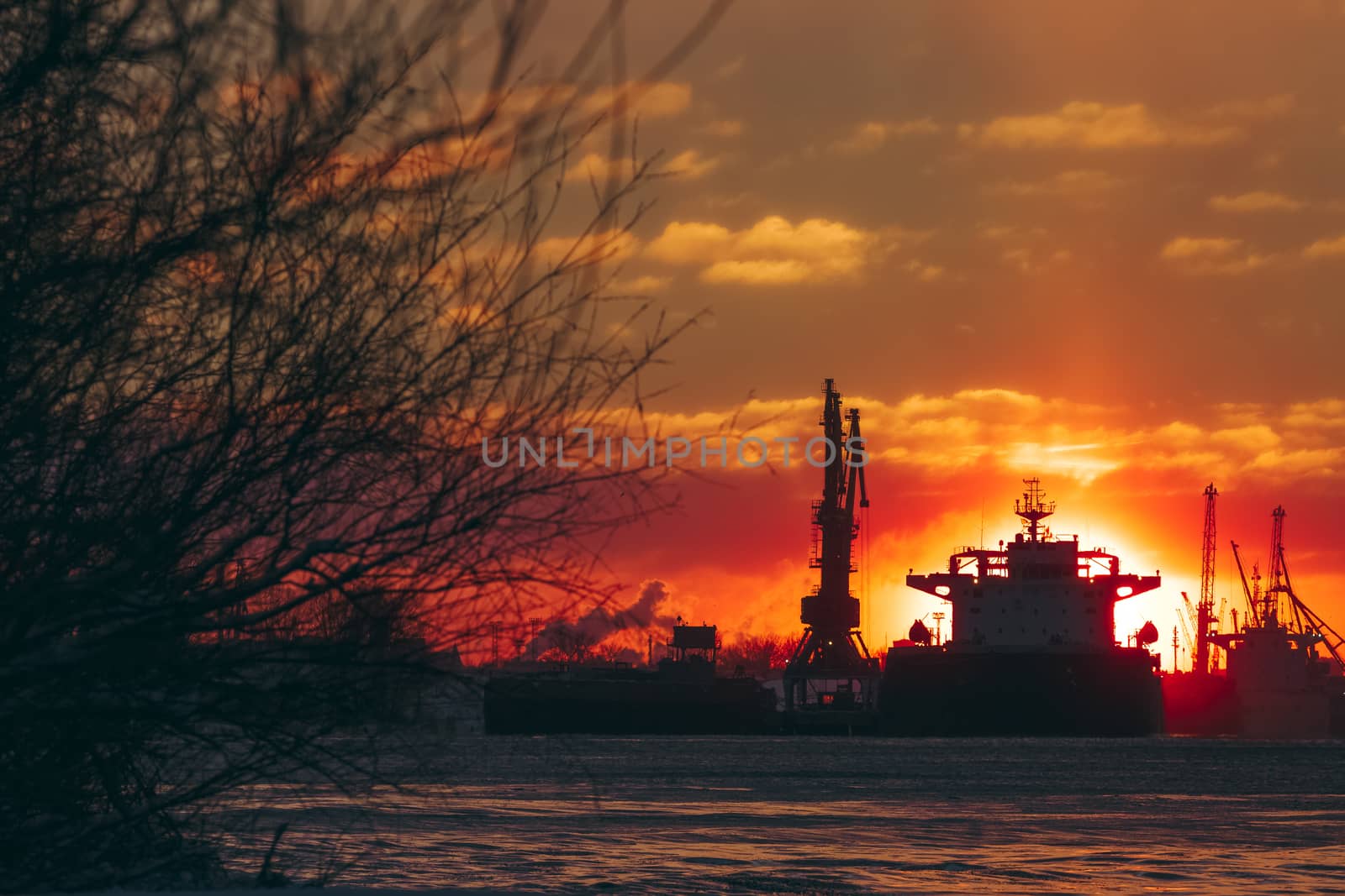 Colorful winter sunrise against the cargo port