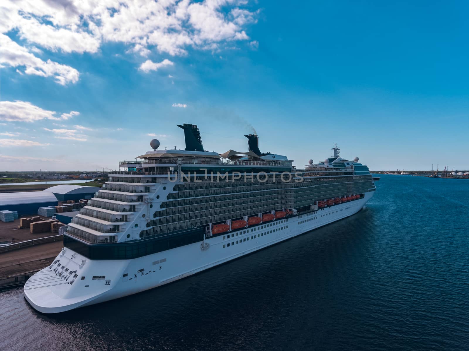 Big white passenger ship moored at the cargo port