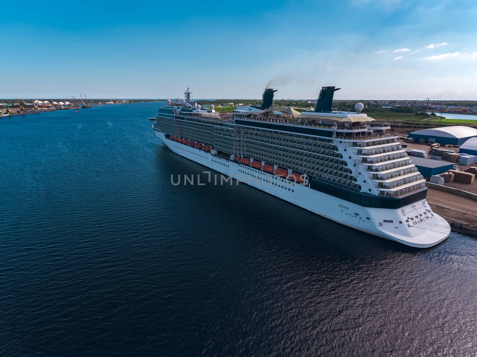 Big white passenger ship moored at the cargo port