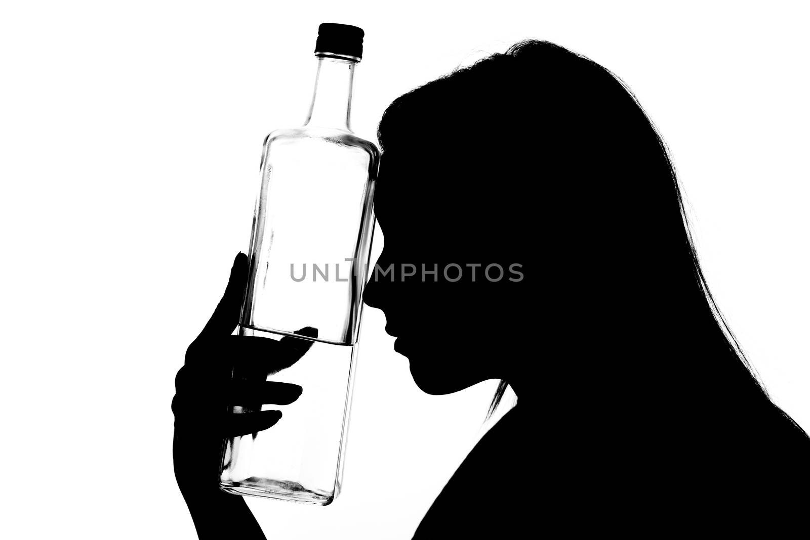 Silhouette of a young drunk woman with a glass bottle.