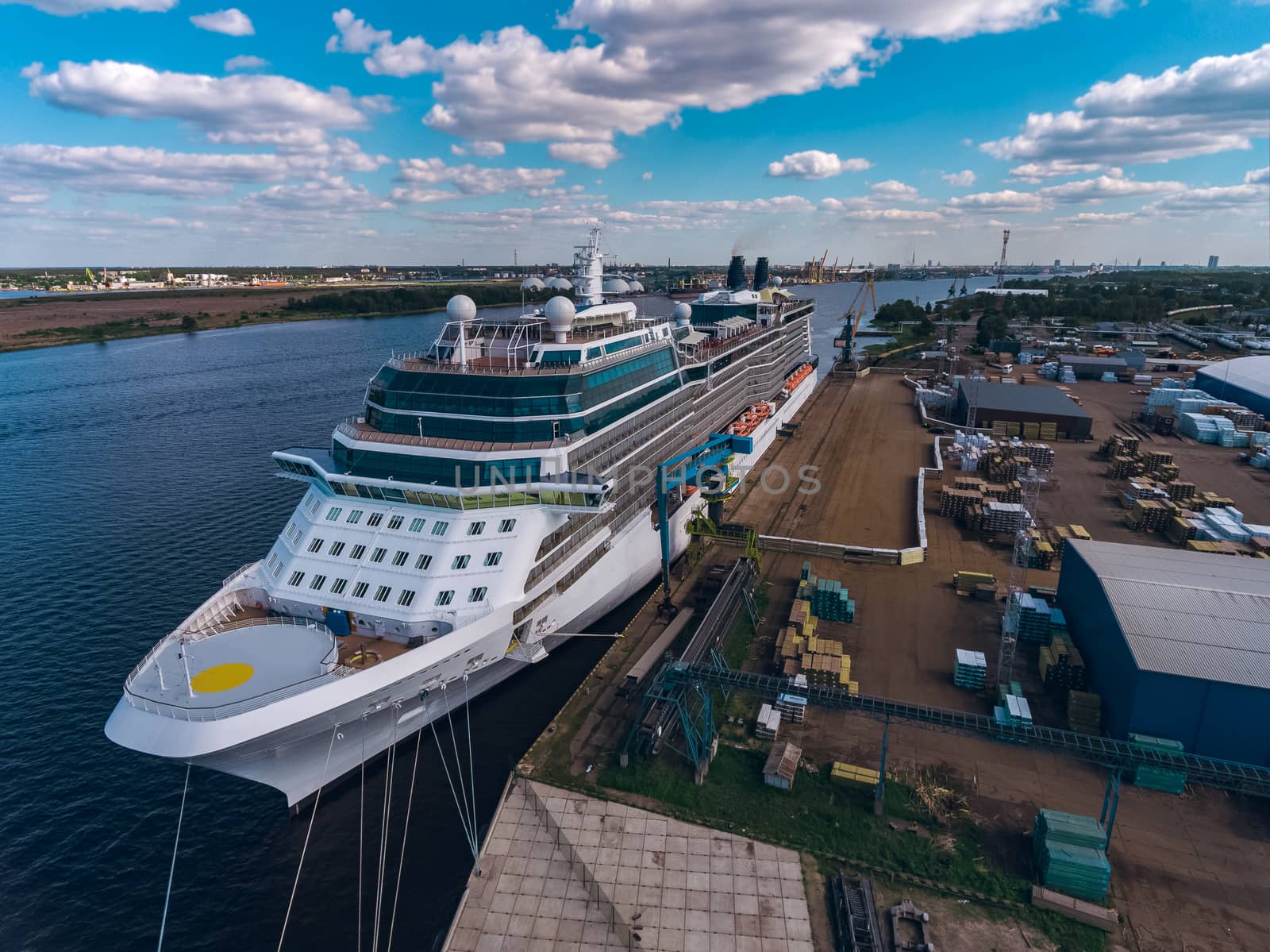Big white passenger ship moored at the cargo port
