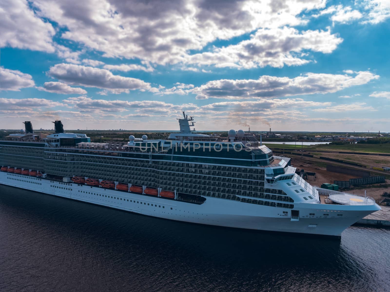 Big white passenger ship moored at the cargo port