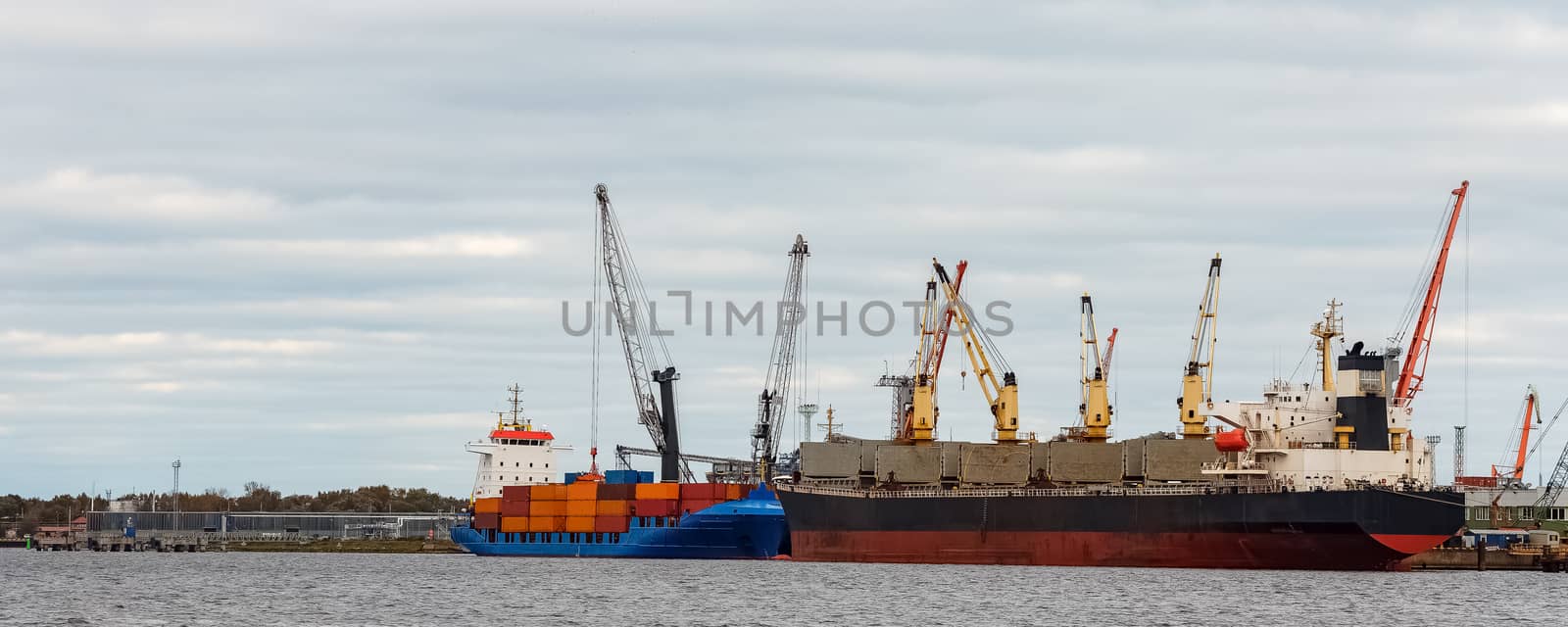 Black cargo ship loading in the port of Riga, Europe