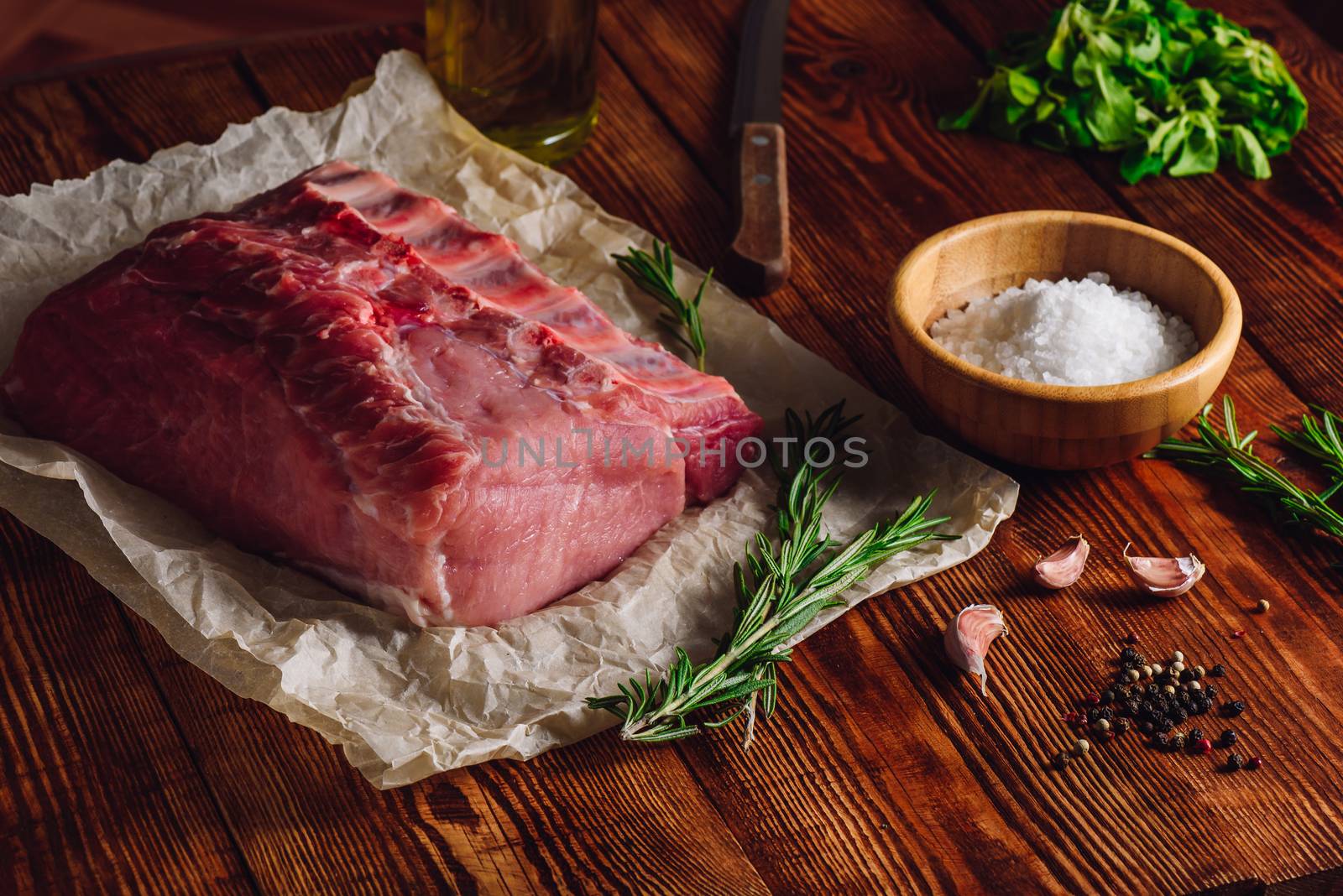 Raw Pork Ribs with Some Spices and Sprigs of Rosemary.