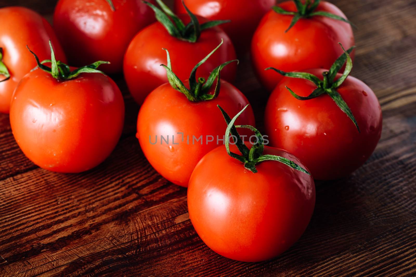 Some Red and Fresh Tomatoes on Wooden Table