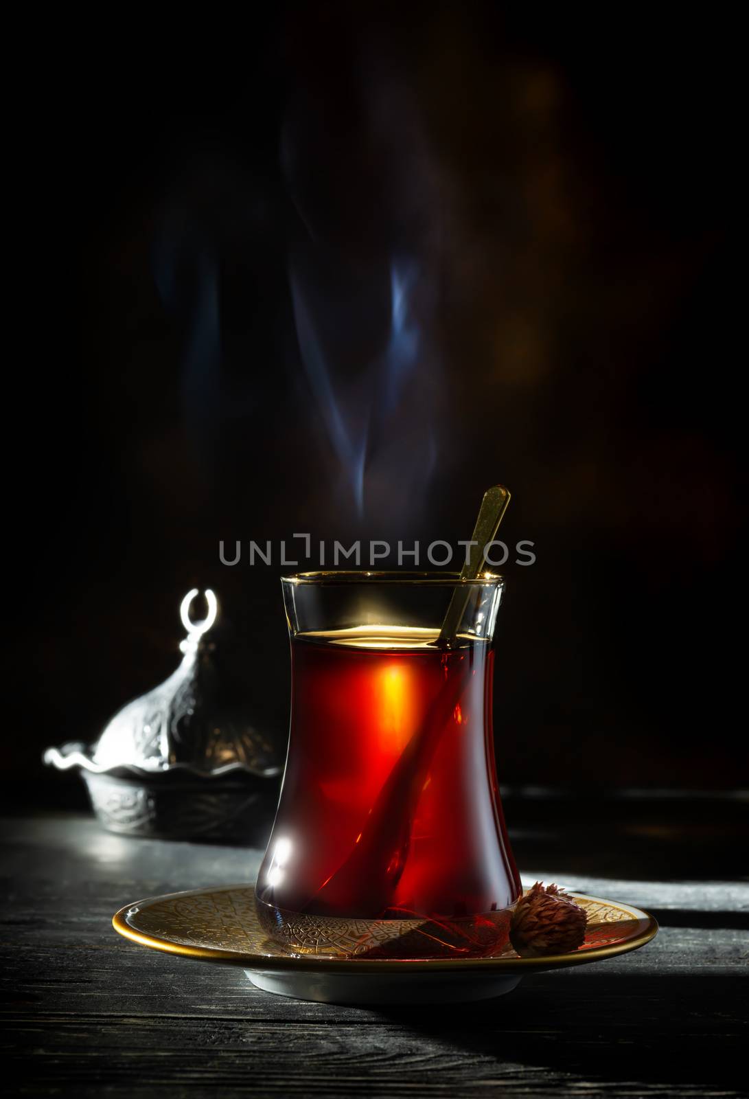 Glass of red turkish tea on a black background