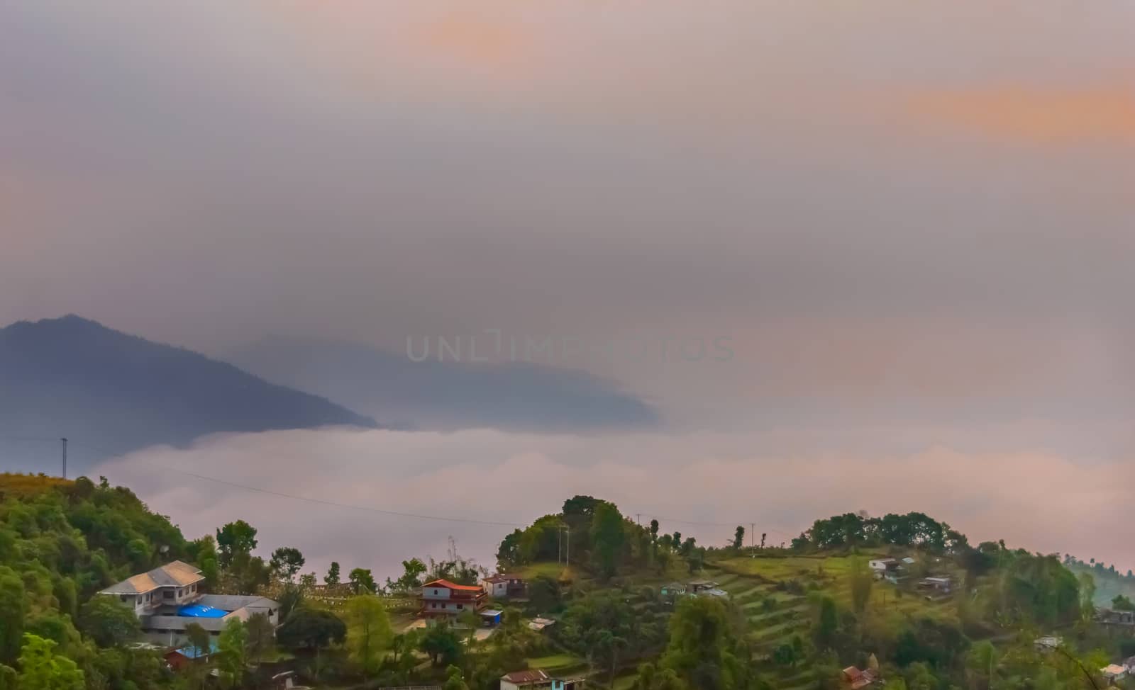 This is a photograph of vibrant color cloudy sky and mountain of a hill station near Sarangkot, Pokhara, Nepal Near Kathmandu. The image taken at dusk, at dawn, at daytime on a cloudy day. The Subject of the image is adventure, inspiration, exciting, hopeful, bright, sensational, tranquil, calm, stormy, stunning. This photography is taken in as landscape style. This photograph may be used as a background, wallpaper, screen saver.