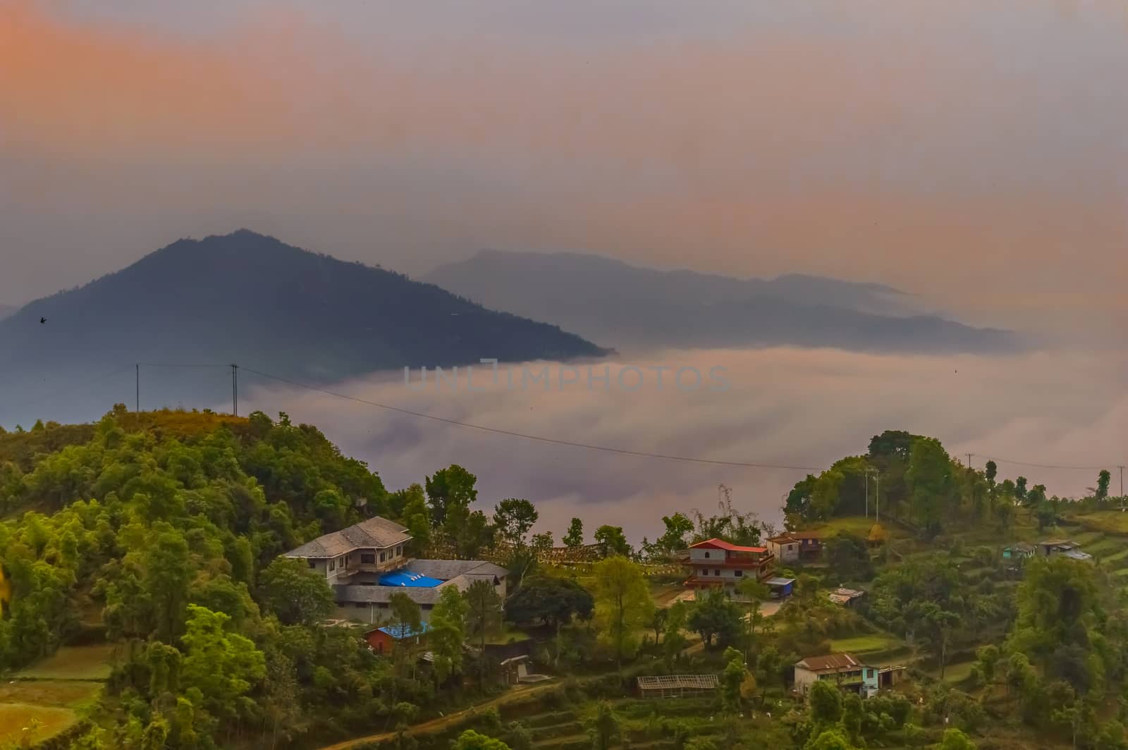 This is a photograph of vibrant color cloudy sky and mountain of a hill station near Sarangkot, Pokhara, Nepal Near Kathmandu. The image taken at dusk, at dawn, at daytime on a cloudy day. The Subject of the image is adventure, inspiration, exciting, hopeful, bright, sensational, tranquil, calm, stormy, stunning. This photography is taken in as landscape style. This photograph may be used as a background, wallpaper, screen saver.