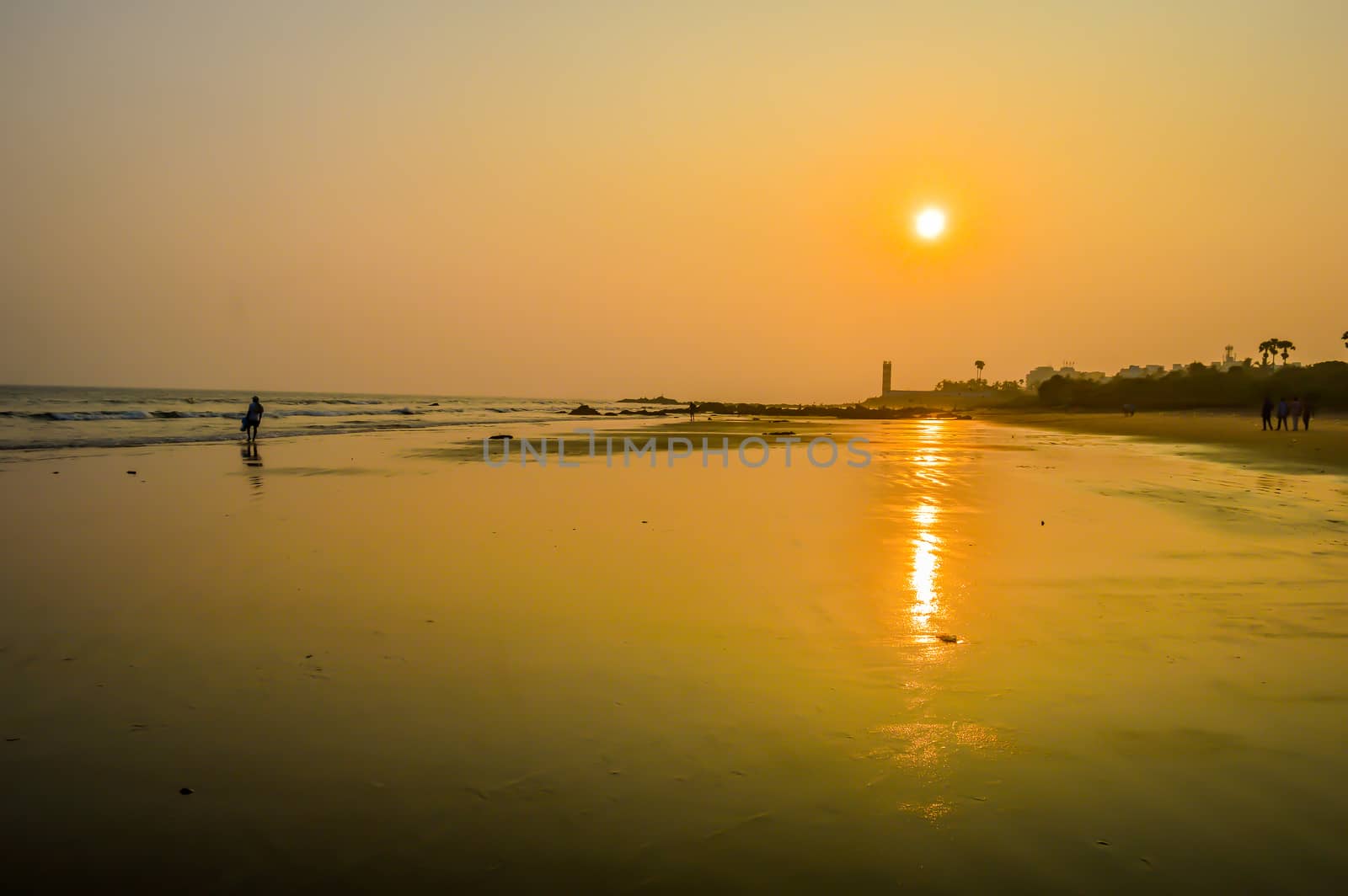 Beautiful sea shore at sunrise or sunset sunset Wild Empty Tropical beach, orange sky, sunlight reflextions on the shore at sunset time on a sunny day in in as landscape style may be used as a background, wallpaper, screen saver banner Travel vacation concept. The image is exciting, bright, sensational, tranquil, calm, stunning