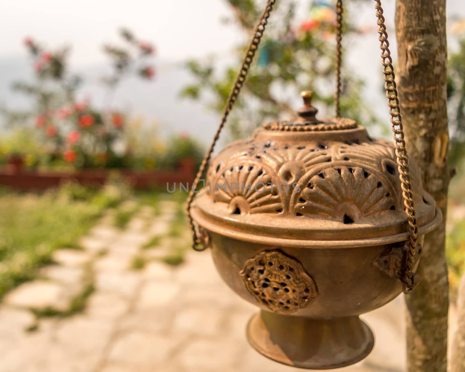 Metal Dhoop Batti Stand Hanging on a tree branch