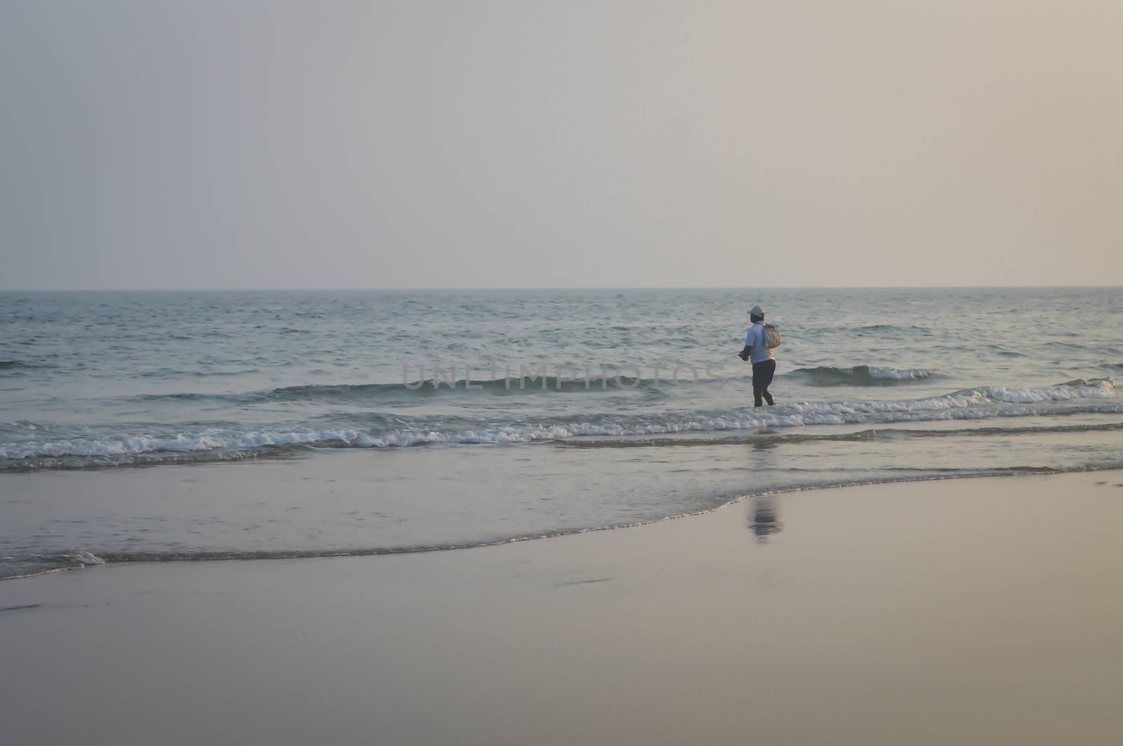 Male fisherman catching fish one evening summer day with fishing net, the traditional way of fishing of small fishing village in coast of Indian. by sudiptabhowmick