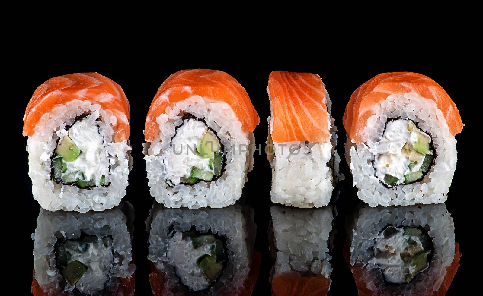 Traditional Japanese Sushi roll Philadelphia. Black background with reflection.