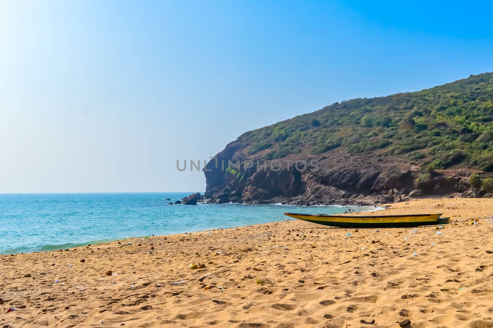 View of Fishing boats on beautiful sea shore at sunrise or sunset. Wild Empty Tropical beach, blue sky, yellow sand, sunlight reflections taken in landscape style may be used as a background, wallpaper, screen saver banner Travel vacation concept. The image is exciting, bright, sensational, tranquil, calm, stunning.