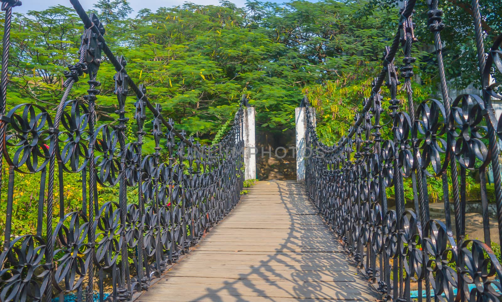 Landscape view of Long Steel Suspension bridge above the canal i by sudiptabhowmick