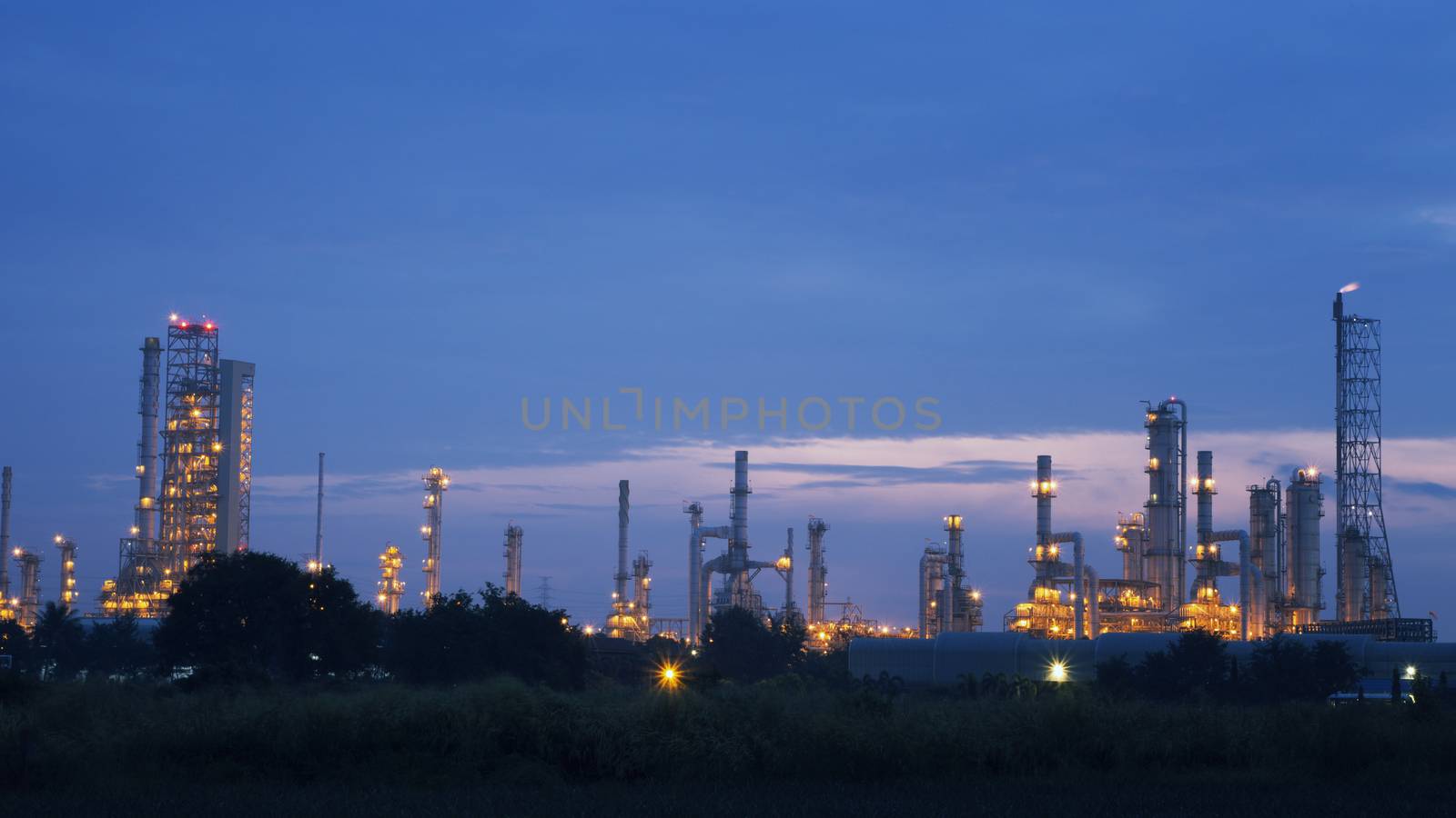 Oil, gas industry and refinery at sunrise with  purple sky in the morning.