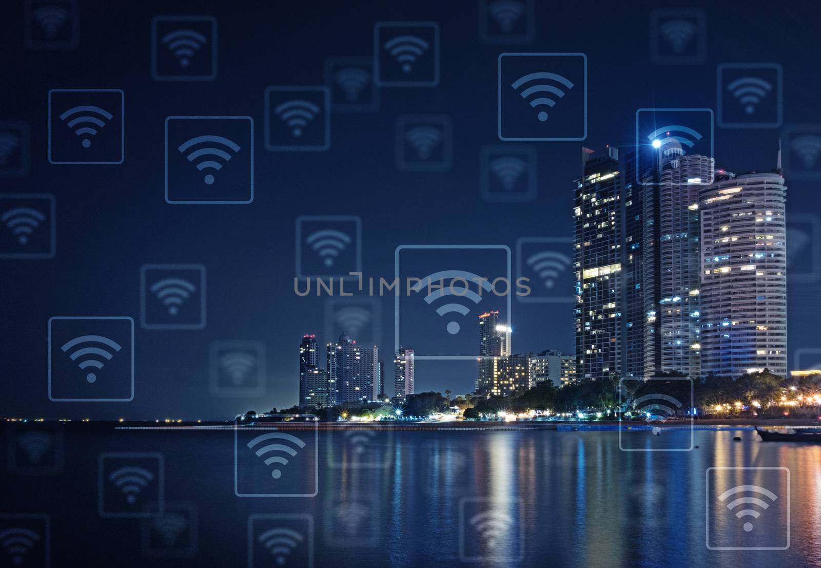 A long exposure of nigh cityscape at the beach. Light from building is reflect on the water. WiFi icon pattern.