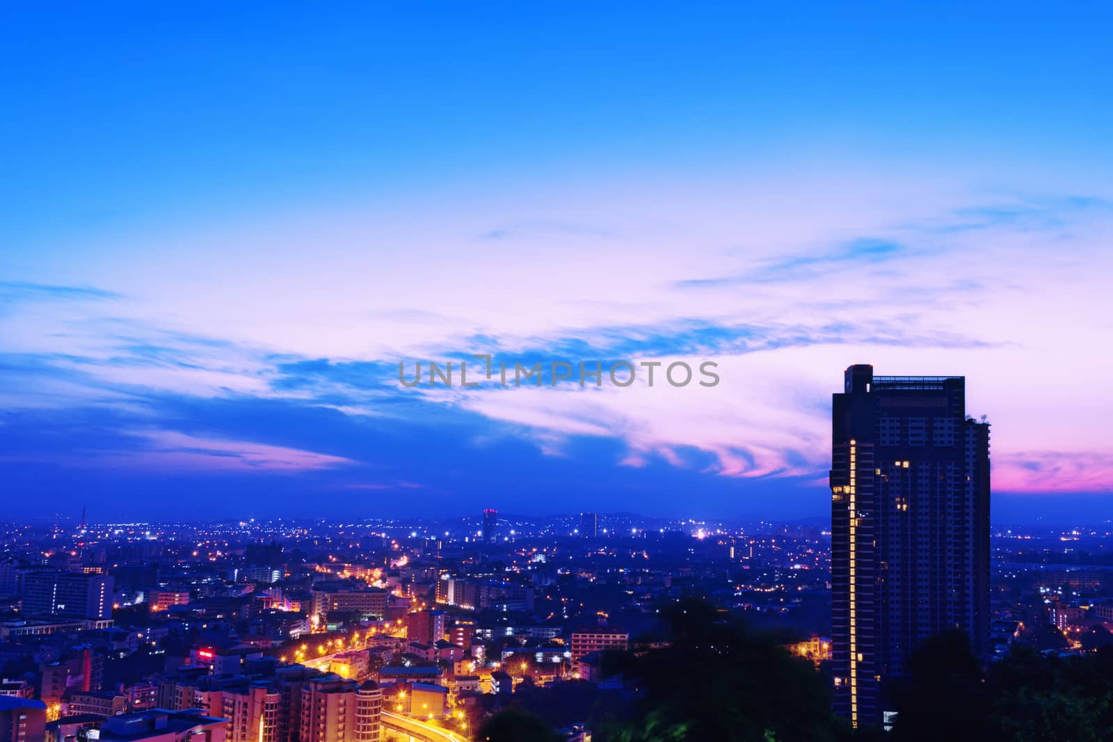 Night cityscape with gold light on the highway. Beautiful sunrise sky background.