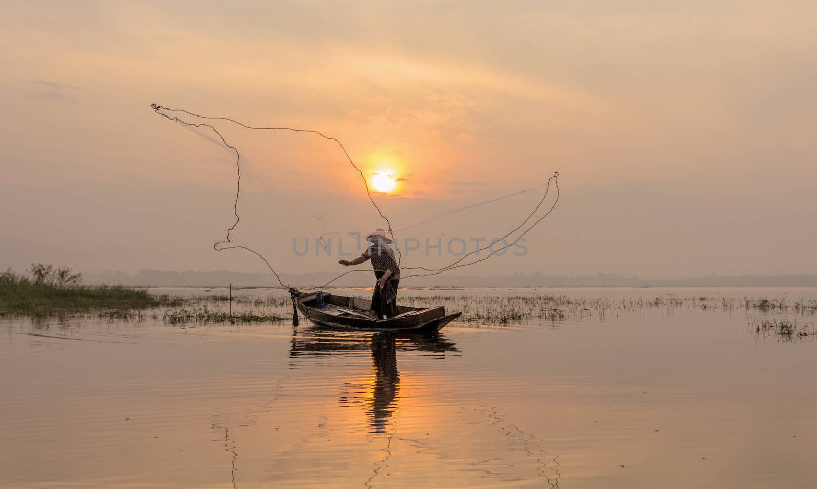 Silhouette of fishermen casting for catching the fish on the woo by 0864713049