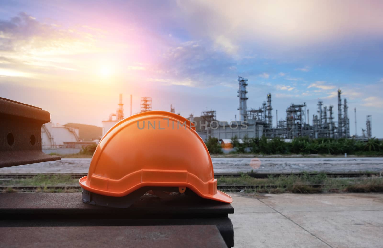 Helmet construction on the metal bar with industrial background.