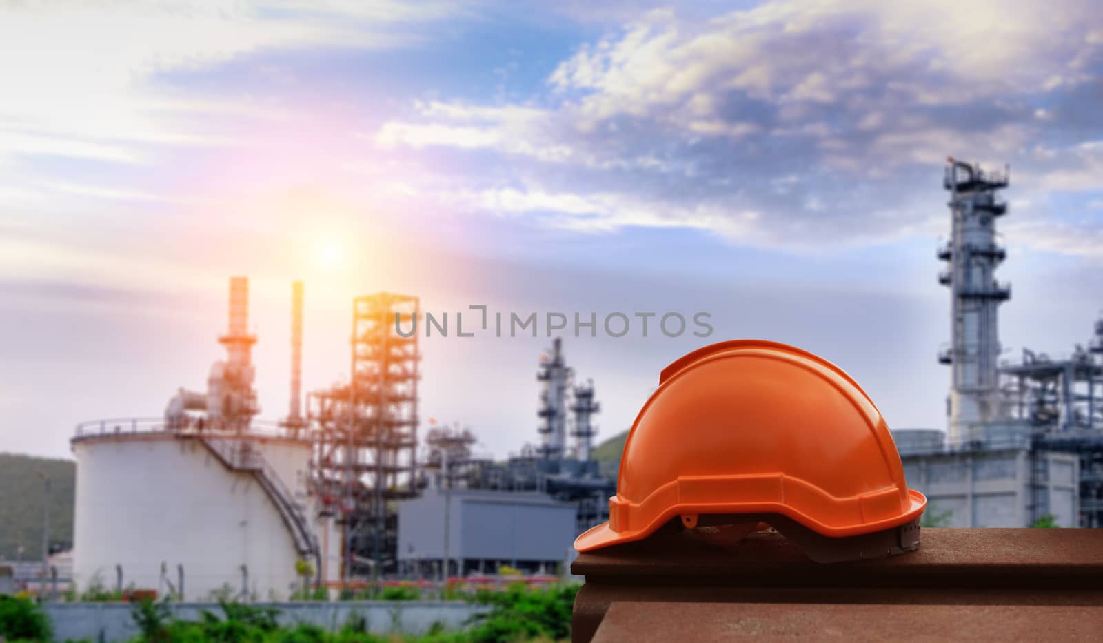 Helmet construction on the metal bar with industrial background.