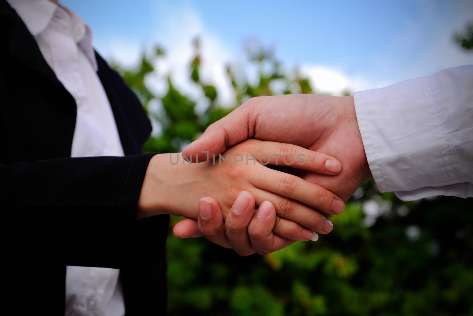 The engineer guy is shaking hands with construction manager. Dealing the contract.